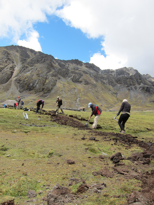 Digging a narrow trench for PVC pipes to carry potable water.